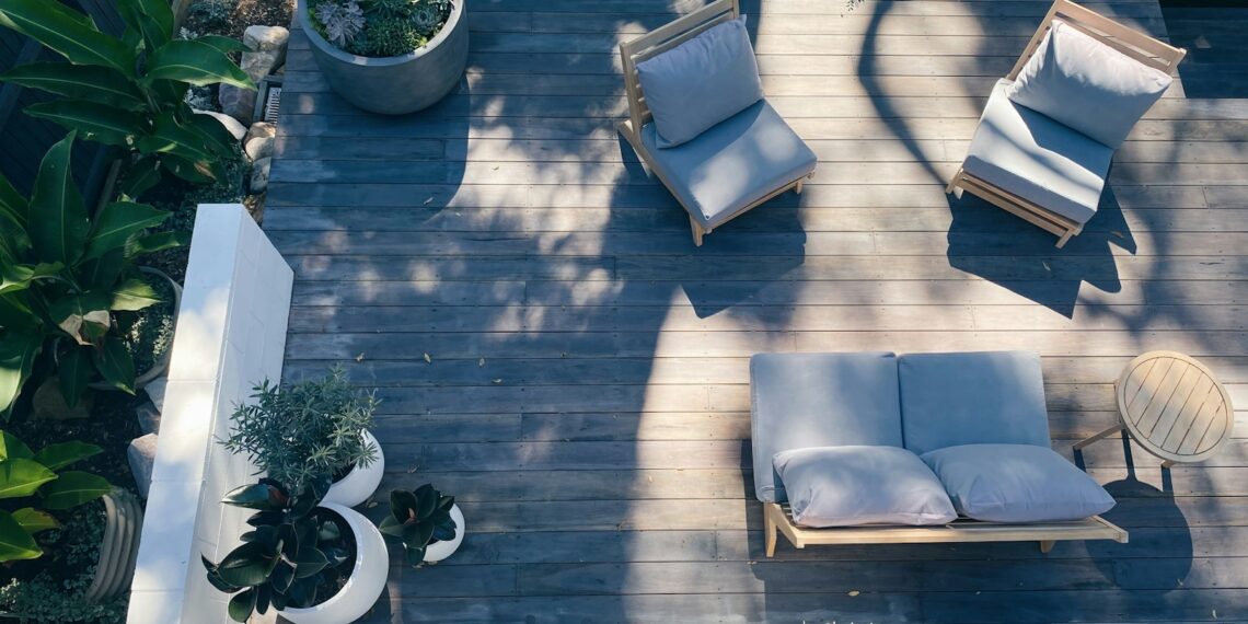 brown wooden framed blue padded armchair
