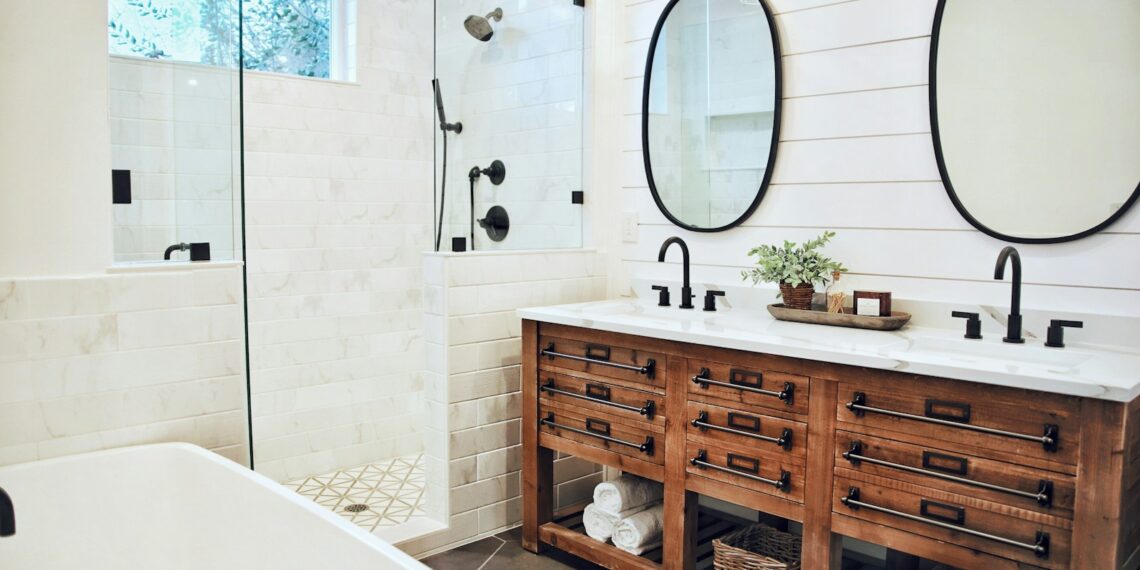 white ceramic bathtub near brown wooden cabinet